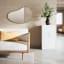 Umbra Hubba Pebble Mirror - Brass In A Living Room Setting 