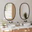 Umbra Hub Oval Mirror - Black In A Bathroom Setting 