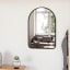 Umbra Hub Arched Mirror - Black In A Bedroom Setting 