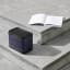 Bang & Olufsen Beolit 20 Bluetooth Speaker - Black Anthracite on the staircase with a book