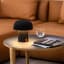 Kooduu Sensa Table Lamp - Anthracite on a coffee table