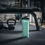 Contigo Shake & Go 2.0, 820ml - Bubble Tea next to a bench with weights