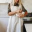 Me Thyme Cross-Over Apron - Light Oatmeal worn in the kitchen
