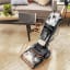Bissell Revolution HydroSteam Carpet Cleaner - Black/Gold on a rug