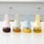 Zuutii Oil Dispenser with Brush, 130ml - Creamy Yellow on the table with other colours