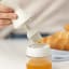 Zuutii Oil Dispenser with Brush, 130ml - Light Cream on the table