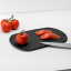 Blim Plus Skateboard Chopping Board - Carbon Black on the kitchen counter