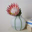 Thread Office Green Stripe Round Vase on side table with flower