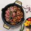 Victoria Signature Soft Seasoned Finish Double Handle Skillet, 33cm with food on the table