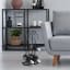 H & S Collection Black Metal Wine Rack next to a couch