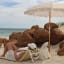 Sunnylife Reclining Beach Chair - Mango Bay Golden Mustard Stripe at the beach
