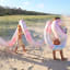 Sunnylife Giant Inflatable Noodle Snake - Tie Dye at the beach