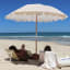 Sunnylife Beach Umbrella - Mango Bay Golden Mustard Stripe at the beach