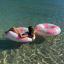 Sunnylife Tube Pool Ring - Bubblegum Pink floating in water
