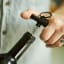 Gentlemens Hardware Mini Corkscrew Keychain on a wine bottle