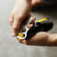 Gentlemens Hardware Mini Guitar Bottle Opener opening a beer bottle