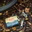 Gentlemens Hardware Bicycle Puncture Repair Kit on the ground with a bicycle