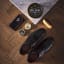 Gentlemens Hardware Travel Shoe Shine Kit with shoes on the floor
