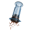AeroPress Clear Blue Coffee Maker in use pushing out coffee