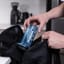 AeroPress Clear Blue Coffee Maker being put into a backpack 
