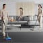 Dyson V15 Detect Submarine Cordless Vacuum Cleaner in use cleaning floor, couch and carpet