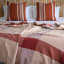 Aranda Garnet & Canyon Geometry Protea Throw, 200cm x 240cm on the bed