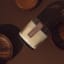 Nude Home Fragrances Cabin Fever Wood Wick Candle, 300ml on counter with decor