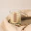 Nude Home Fragrances Cabin Fever Wood Wick Candle, 300ml on counter and tray