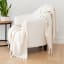 Linen House Pearl Embrace Throw on a chair