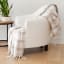Linen House Checkerboard Embrace Throw on a chair