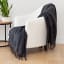Linen House Steel Embrace Throw on a chair