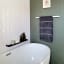 Joon Mila Slim Shower Shelf, 35cm on a wall next to the bathtub