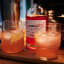 TOMA Handcrafted Raspberry Liqueur, 500ml on the table with a glass
