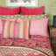 India Ink Peach Fullard Pillowcases, Set of 2 on the bed with other pillows