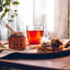 Doubleshot Coffee & Tea Premium Loose Leaf Peach & Ginger Green Rooibos Tea, 80g on the table