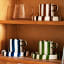 Nicolson Russell Chelsea Striped Cup & Plate, Set of 2 - Brown on a shelf with blue and green set