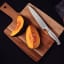 Tramontina Stainless Steel Utility Knife, 15cm on a chopping board
