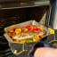 Ooni Roasting Pan - Large with food in an oven