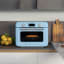 Smeg Retro Countertop Steam Oven - Pastel Blue on the kitchen counter