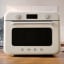 Smeg Retro Countertop Steam Oven - Vintage Cream on the kitchen counter