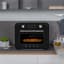 Smeg Retro Countertop Steam Oven - Glossy Black on the kitchen counter