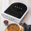 Smeg Portable Induction Plate with Probe - Matte White with a bowl of food