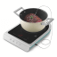 Smeg Portable Induction Plate with Probe - Matte Emerald Green measuring the temperature of the meat