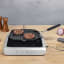 Smeg Portable Induction Plate with Probe - Matte Black on the table