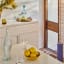 Popstrukt Bon Bon Buddy Sideboard - Soft White with a jar of water and glasses