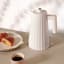 Alessi Plisse Electric Kettle, 1.7L - White on the table