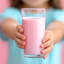 NOMU Reduced Sugar Pink Milk, 250g in a glass