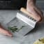 Mason Cash Innovative Kitchen Collection 4-in-1 Bench Scraper with herbs on the table