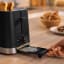 Bosch MyMoment 2-Slice Compact Toaster, 950W - Black on the table with bread