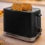 Bosch MyMoment 2-Slice Compact Toaster, 950W - Black on the table with bread